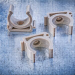 Collection of water pipe clamps on metallic background construction concept.